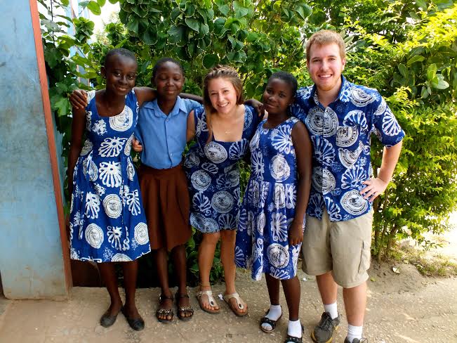 Katie Nelligan ’14 and Kyle Seelig ’15 stand with students from Heritage Academy, for whom they prepared lesson plans on innovative topics. Photo courtesy of Nelligan