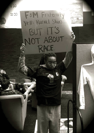 Cayla Young'15 stood in the Steinman College Center in the spring of 2014 in a silent protest after a fraternity member reportedly attacked an African American first-year student with racial slurs. Photo courtesy of F&M BSU's Facebook page.