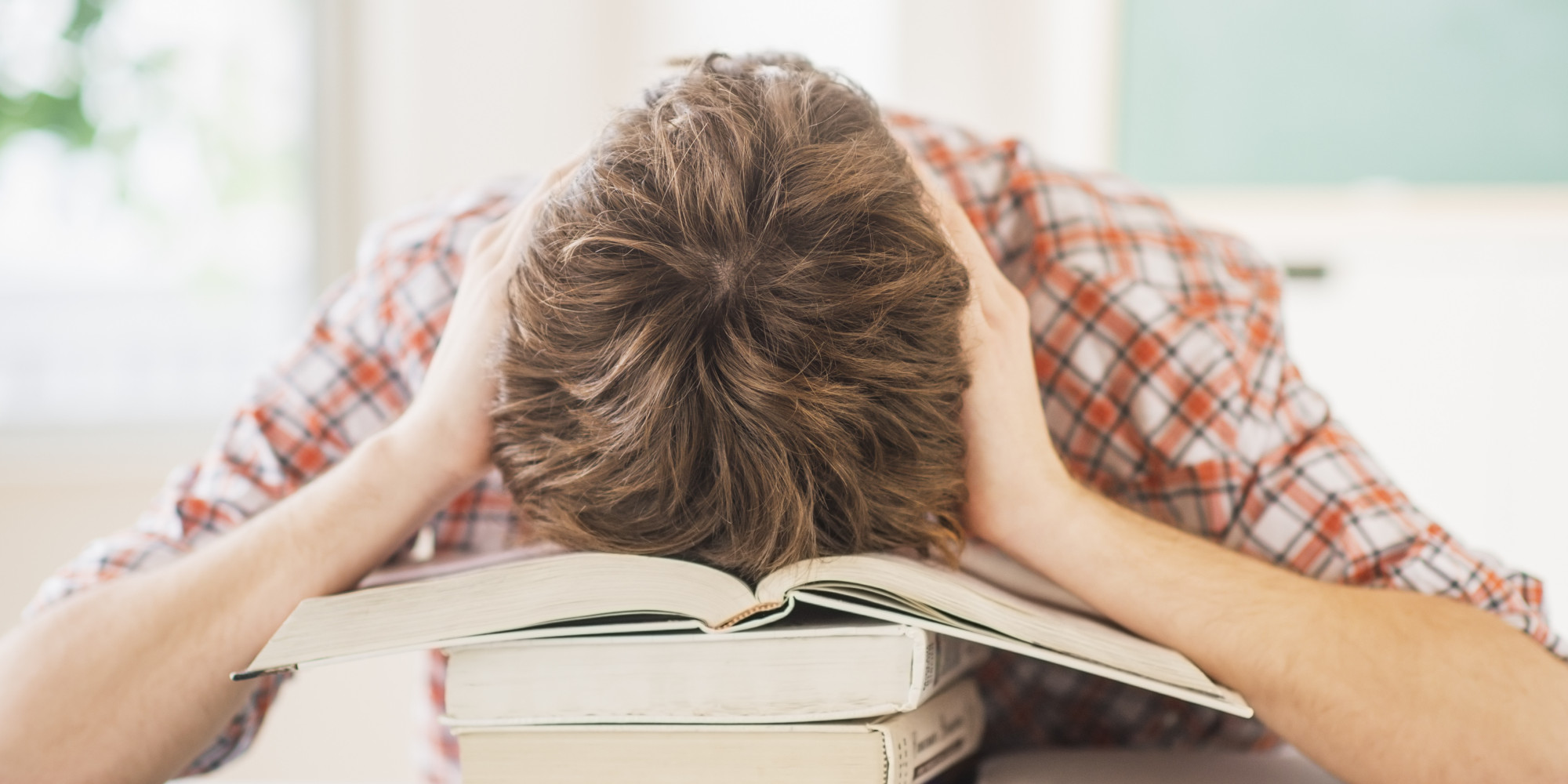 USA, New Jersey, Jersey City, Teenage boy (14-15) sleeping in classroom